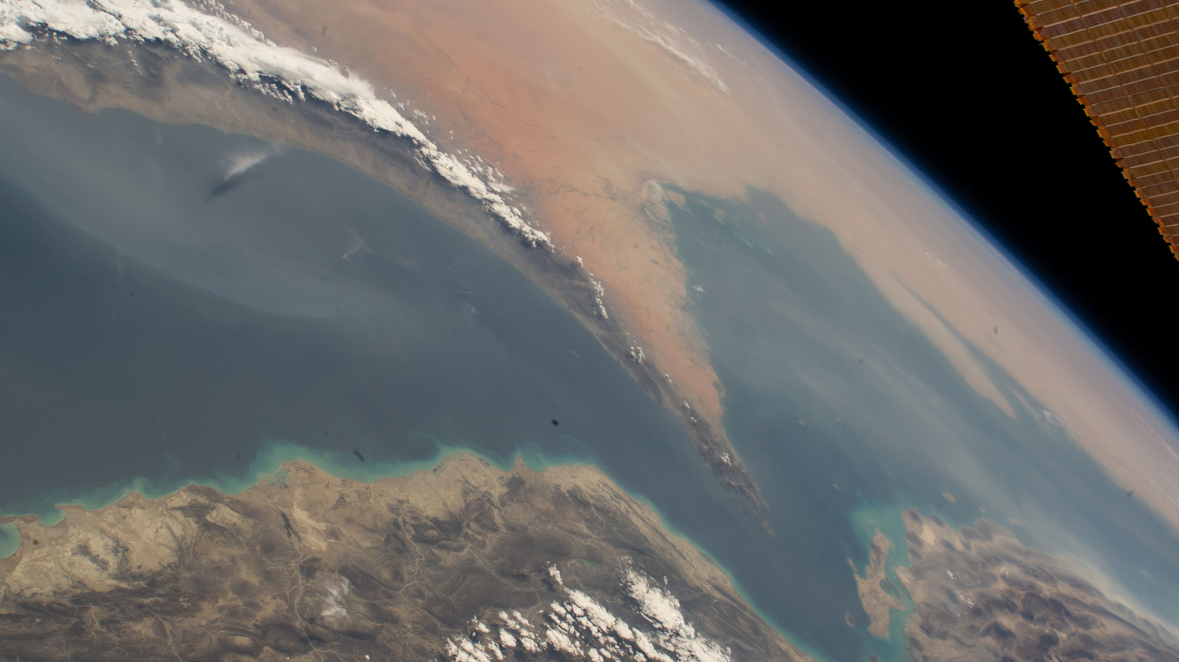 An oblique space photograph of the Strait of Hormuz between Iran and the Arabian Peninsula.