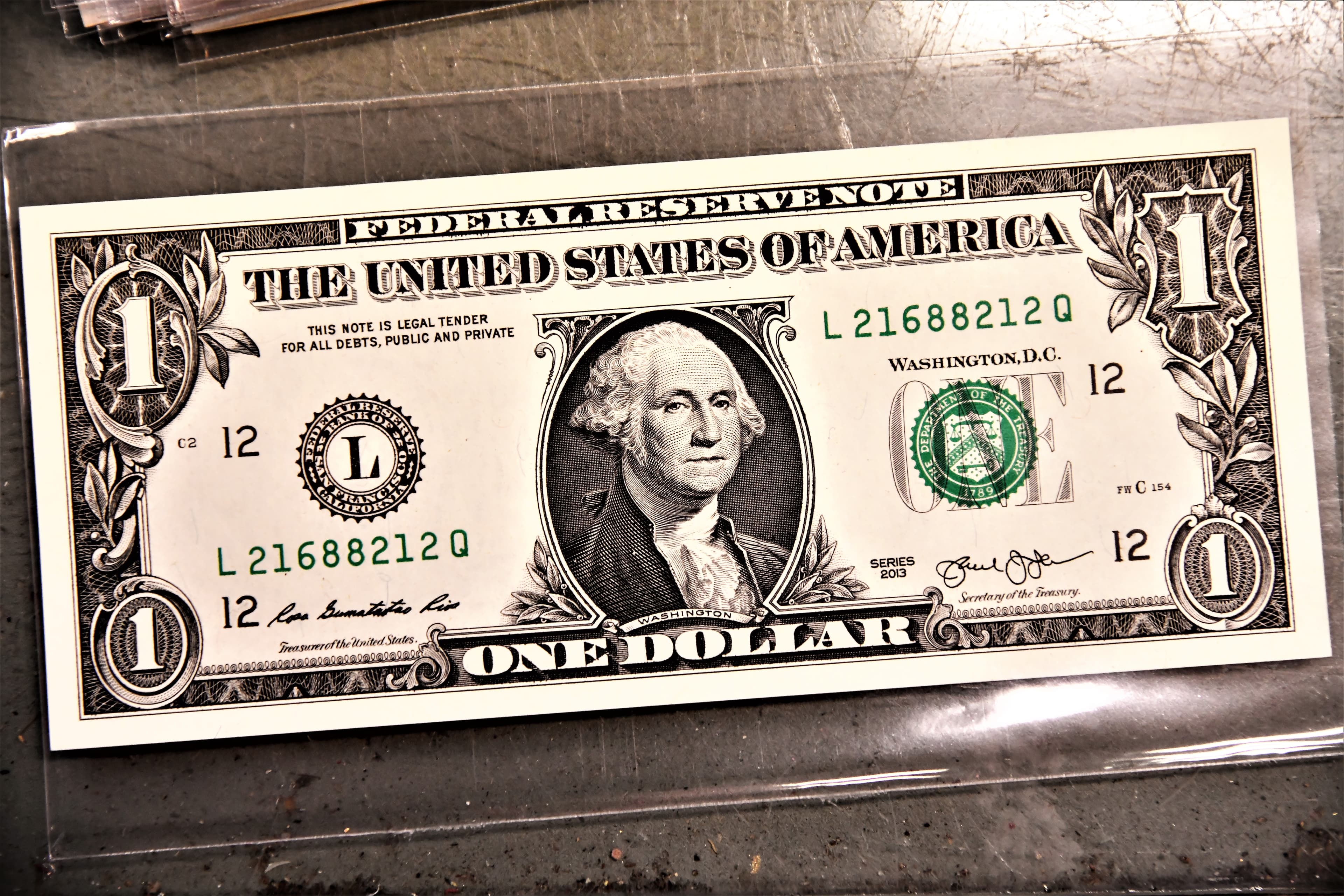 Close-up of a US one-dollar banknote lying on a plain surface
