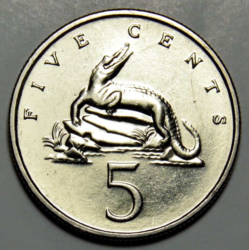 Close-up of the crocodile design and five-cent denomination on a Jamaican coin